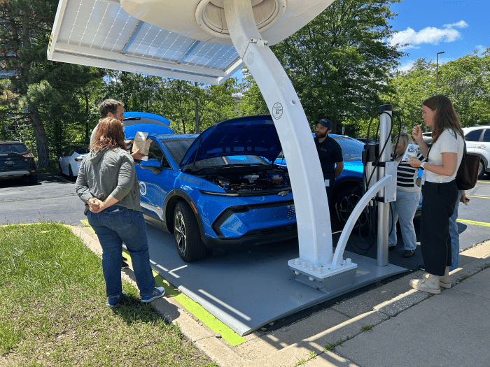 EGLE staff in Jackson check the Beam EV ARC solar chargers.