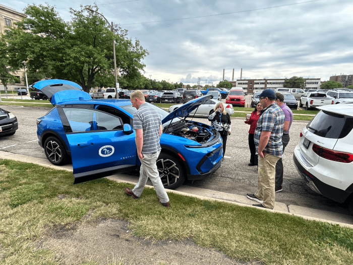EGLE staff in Lansing check out the EV’s engine and features.  