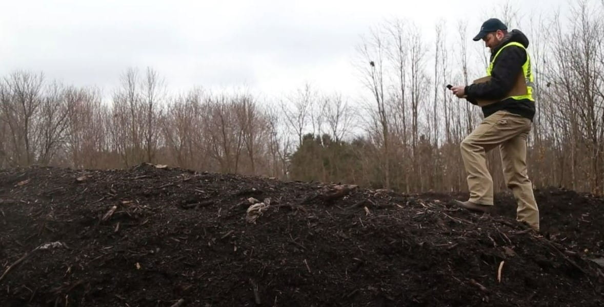 Aaron Hiday, EGLE's compost program coordinator, inspects a compost pile. 