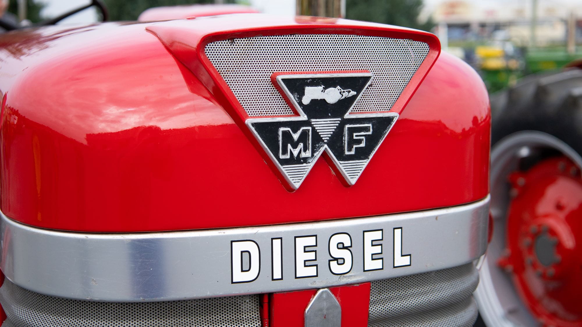 The front end of a red tractor, the word "diesel" is on the front fender