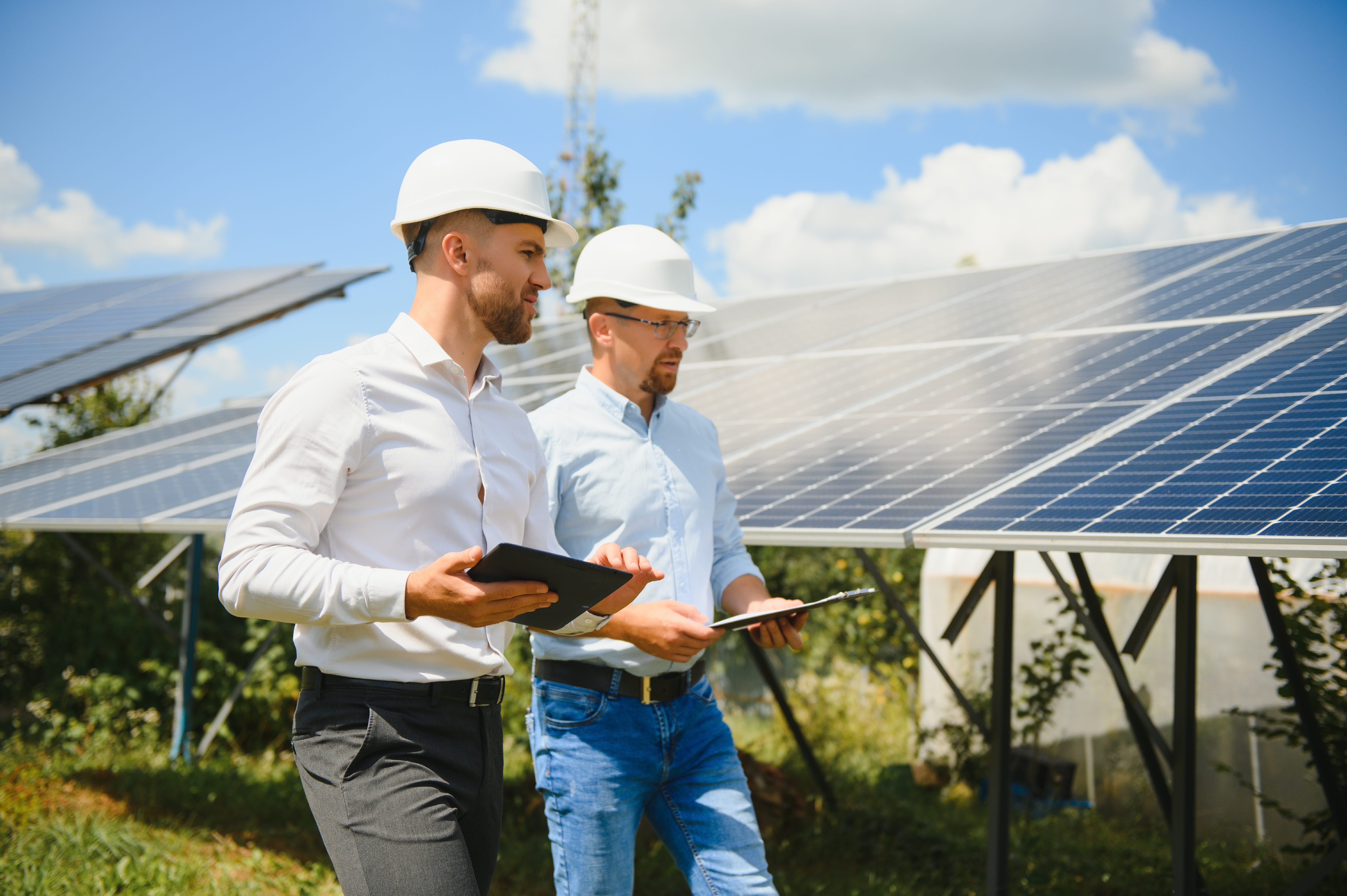 engineer and businessman planning new ecology project around solar panel