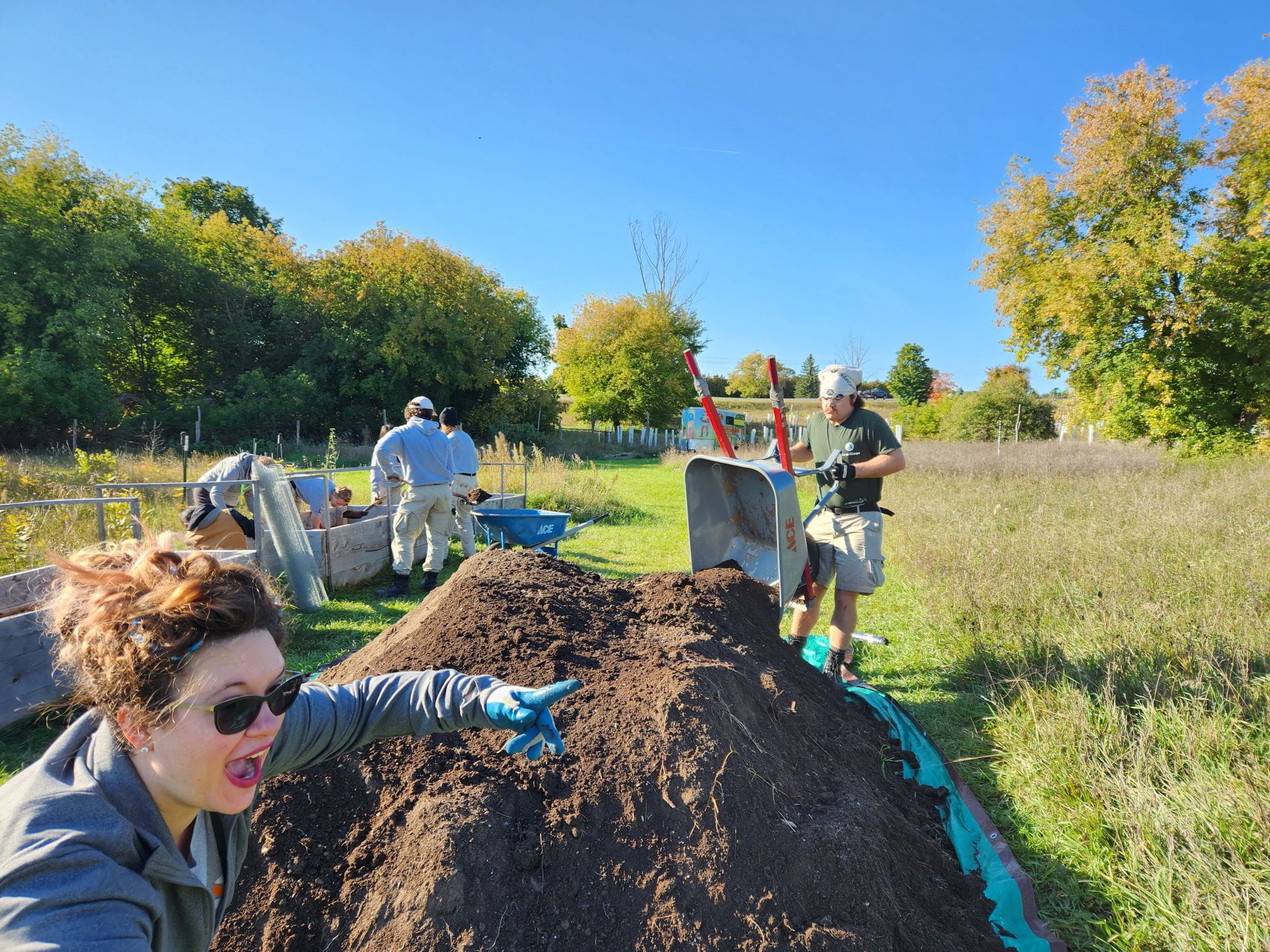 EcoCorps Volunteers work on compost piles at the SEEDS farm at historic Barns Park in Traverse City. Image Source: SEEDS.