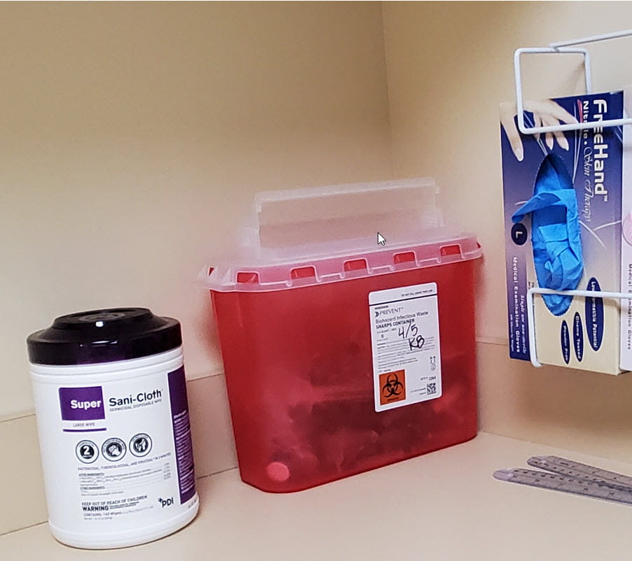 A medical waste bin on a countertop