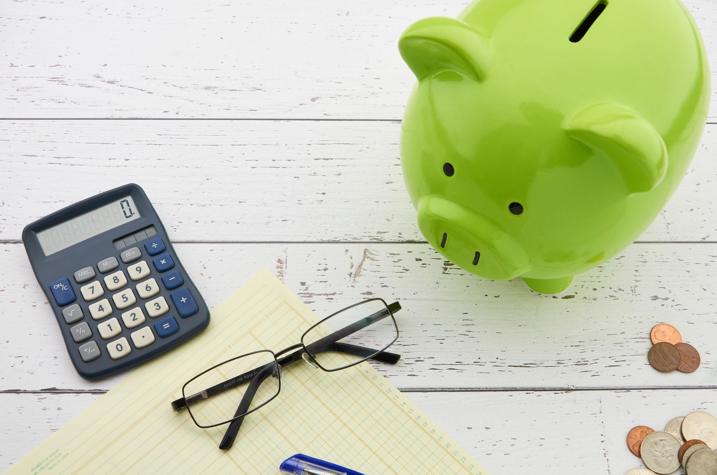 Piggy bank on a desk with a calculator