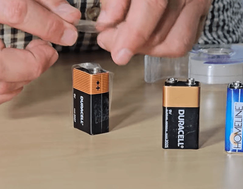 A 9V battery being taped on the anodes for safe transport
