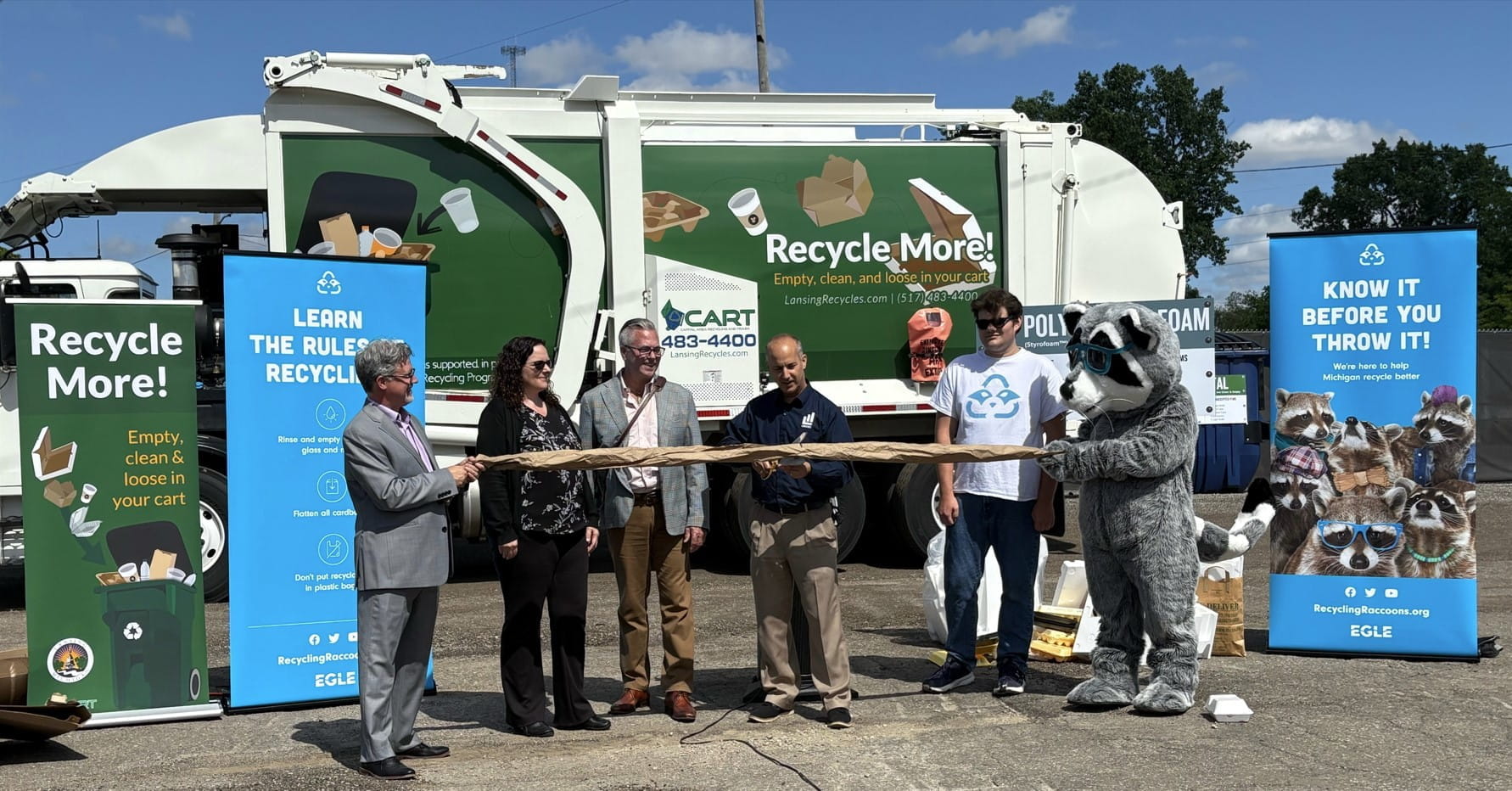 Lansing Mayor Andy Schor cuts the ribbon at the opening of the city’s new recycling drop-off center