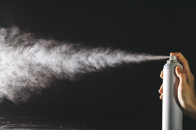 Aerosol can being sprayed