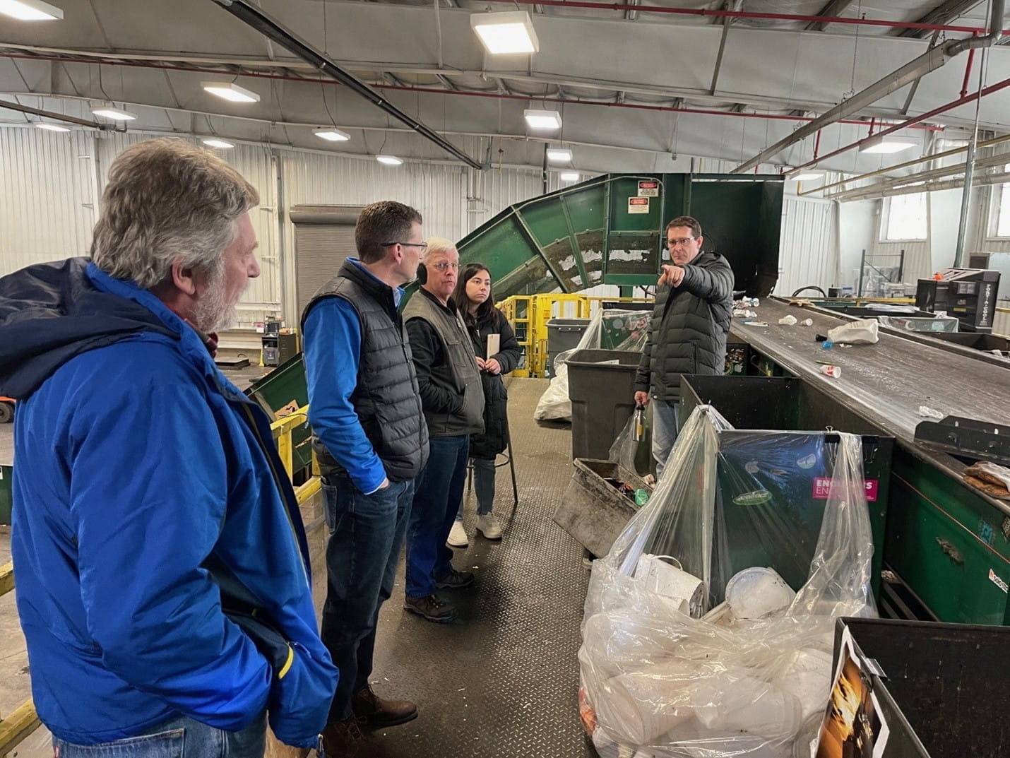 The Holland team touring the Michigan State University Surplus Store and Recycling Center in East Lansing as part of their NextCycle Michigan project. Shown are, from left, Jerry Toninini, materials task force volunteer and local business owner.