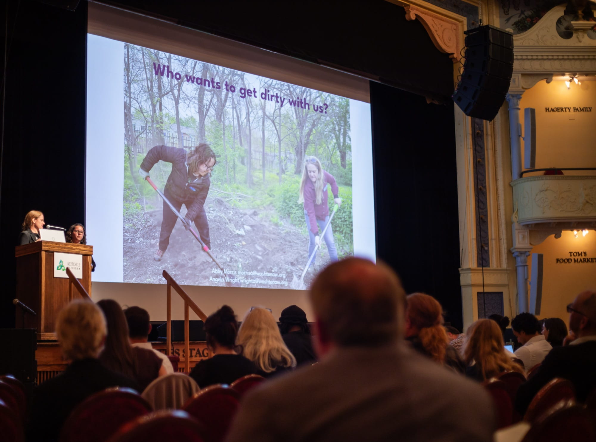 Two presenters of the Washtenaw County team pitch to a live audience during the 2026 NextCycle Michigan Summer Showcase.