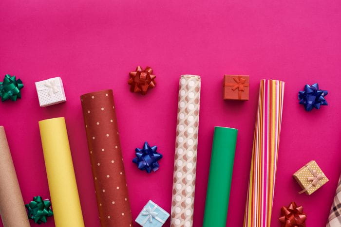 Recyclable wrapping paper, plastic ribbon bows, and tiny wrapped presents