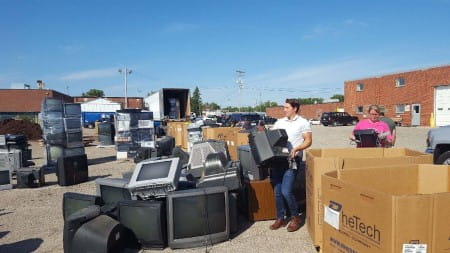 Man sorting electronic waste at collection event
