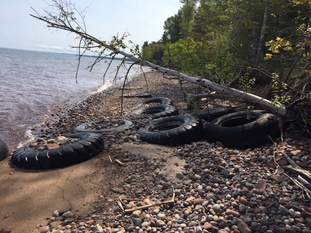 Illegal disposal of scrap tires on a beach in Ontonagon.