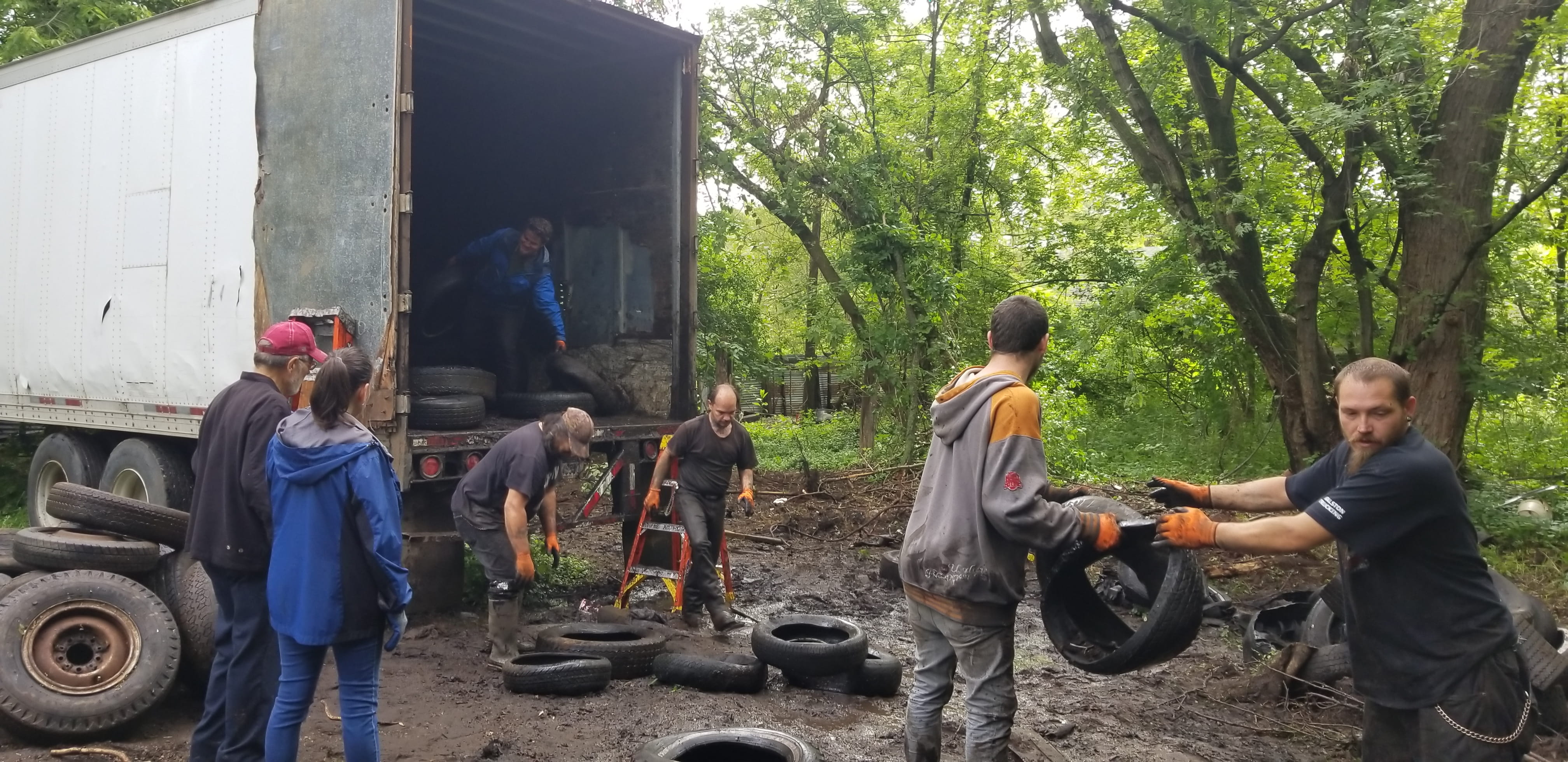 People loading scrap tires onto a truck in Battle Creek.