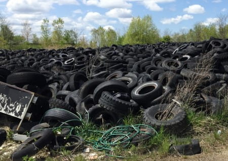 Pile of used tires outdoors