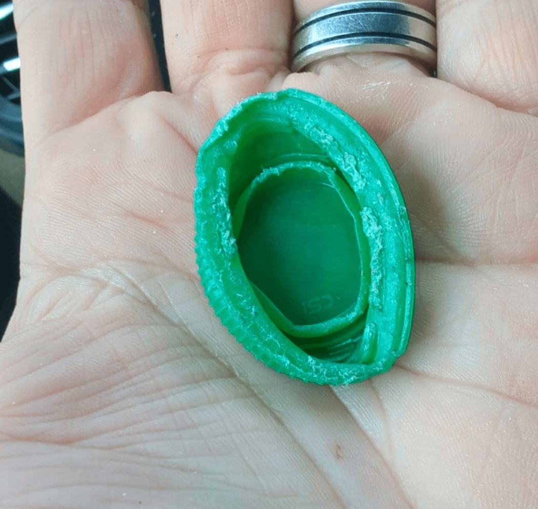 Smashed bottlecap in palm of hand
