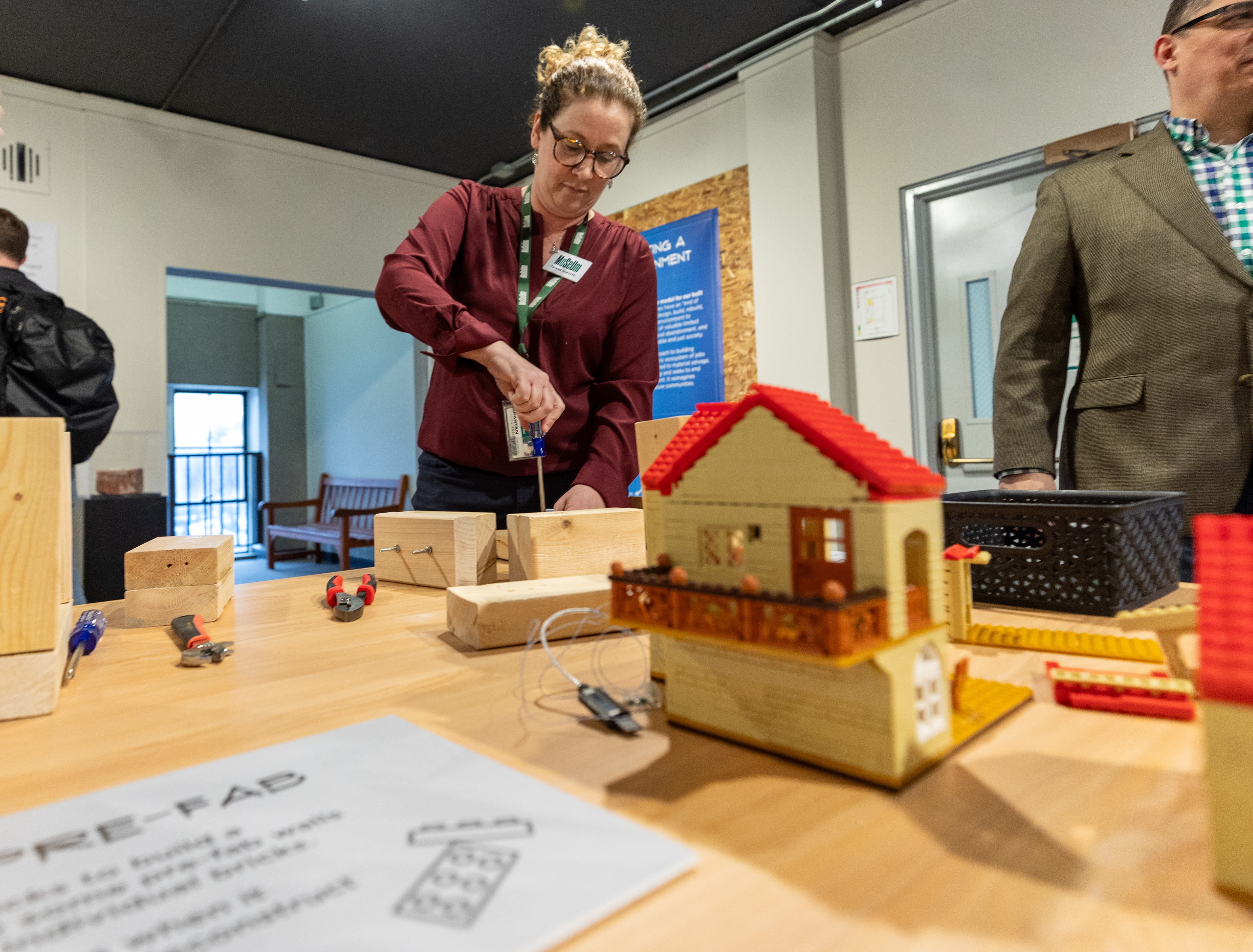 MSU Museum Director of Exhibitions Teresa Goforth interacts with a Lego display at a reception for the EGLE-cosponsored “Domicology” exhibition at the museum. Photo by Aaron Word, courtesy of the MSU Museum.