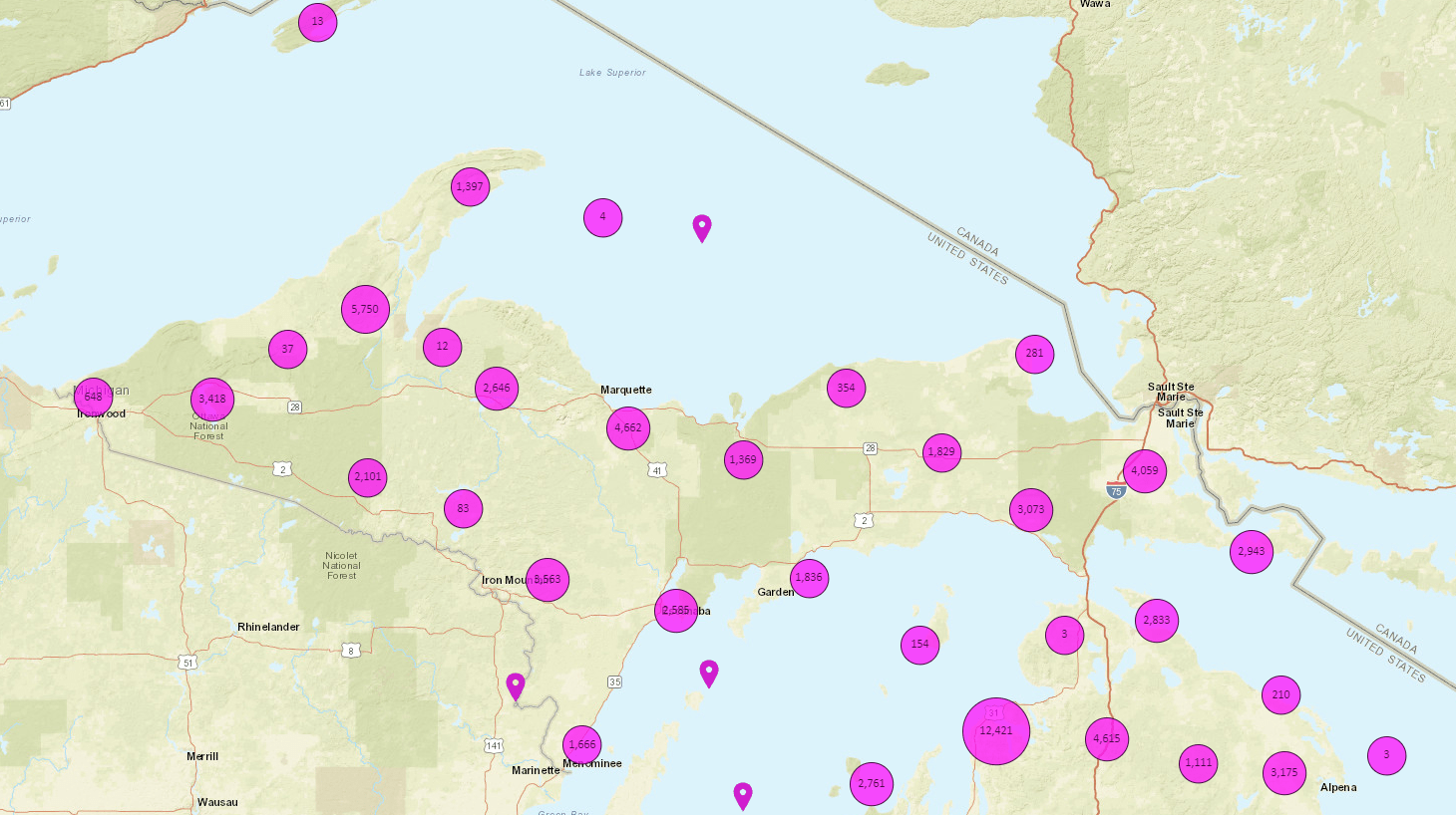Preview of the MiEnviro Portal application; Michigan's Upper Peninsula is covered in purple circles with numbers in them.