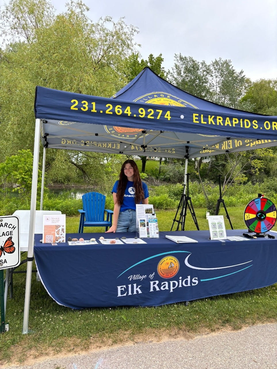 As shoreline management coordinator for the Village of Elk Rapids, MI Healthy Climate Corps member Alexis Goward highlights the village's environmental stewardship at a Nature Fest booth in June. Photo courtesy of Leah Moskovitz.