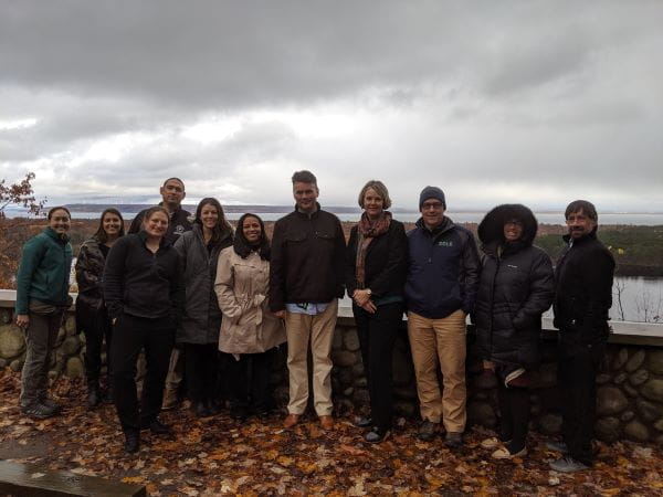 Attendees at the Tribal Summit in Michigan's Upper Peninsula standing on fallen leaves during fall