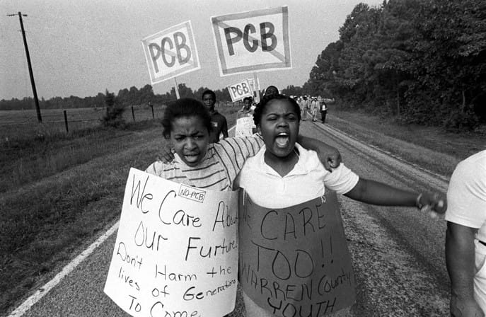Two young girls carrying signs against the PCB landfill in Warren County, North Carolina 1982