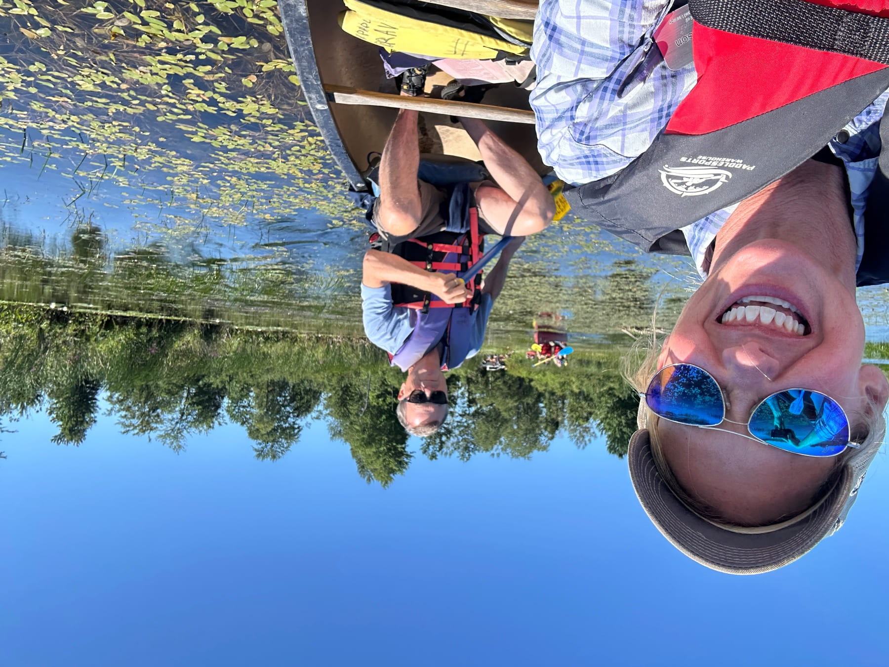 Director Phil Roos and Deputy Director Ann Larson afloat in canoes amongst wild rice