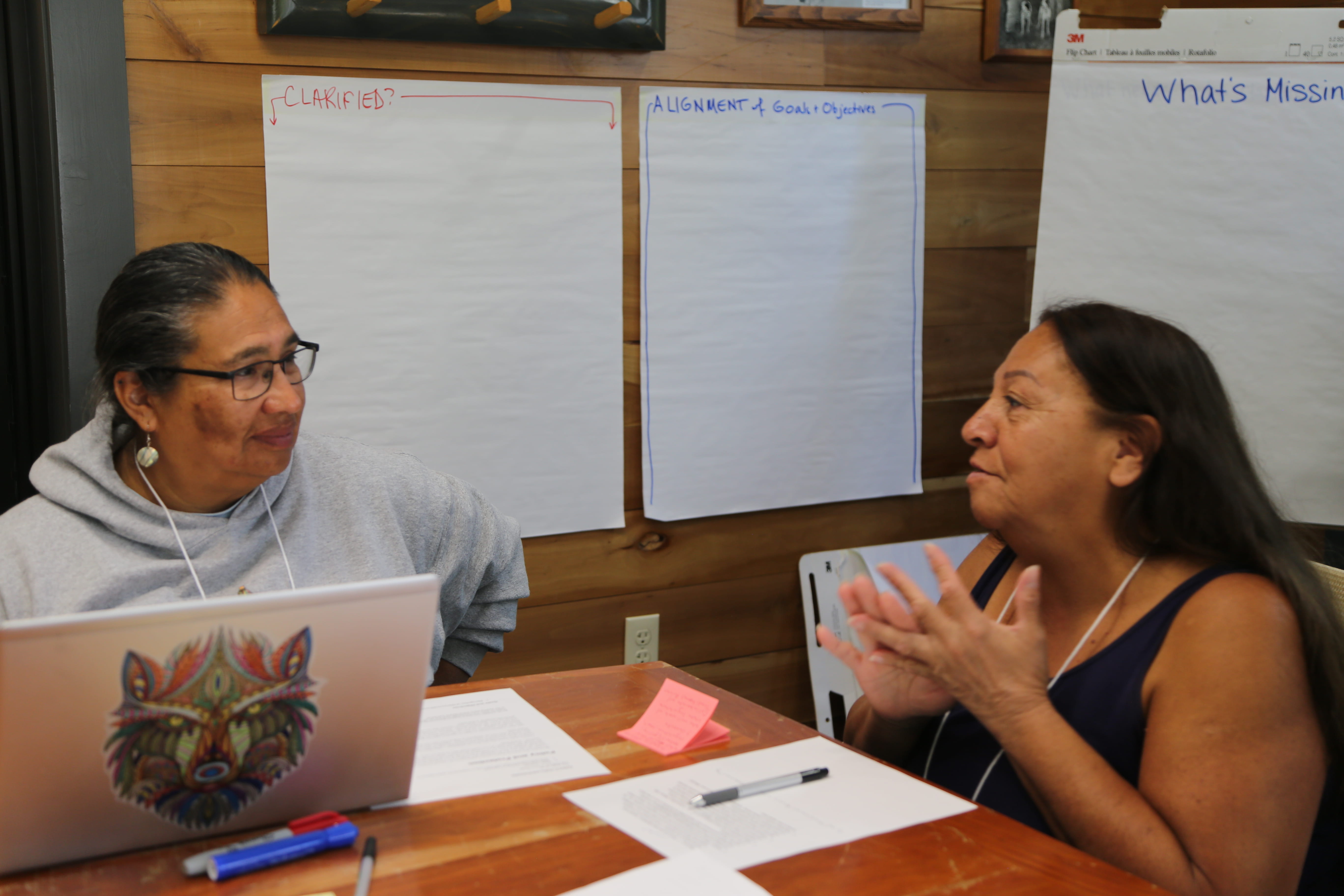Two Manoomin Stewardship Plan workshop participants having a conversation. 