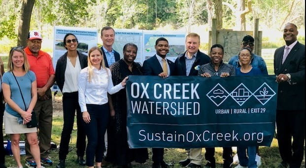 EGLE Director Phil Roos (back row) and Emily Finnell (front row holding banner) of the Office of the Great Lakes, at the Benton Harbor on Sept. 30, 2023 announcing the Great Lakes Restoration Initiative grant. Courtesy of the EPA.