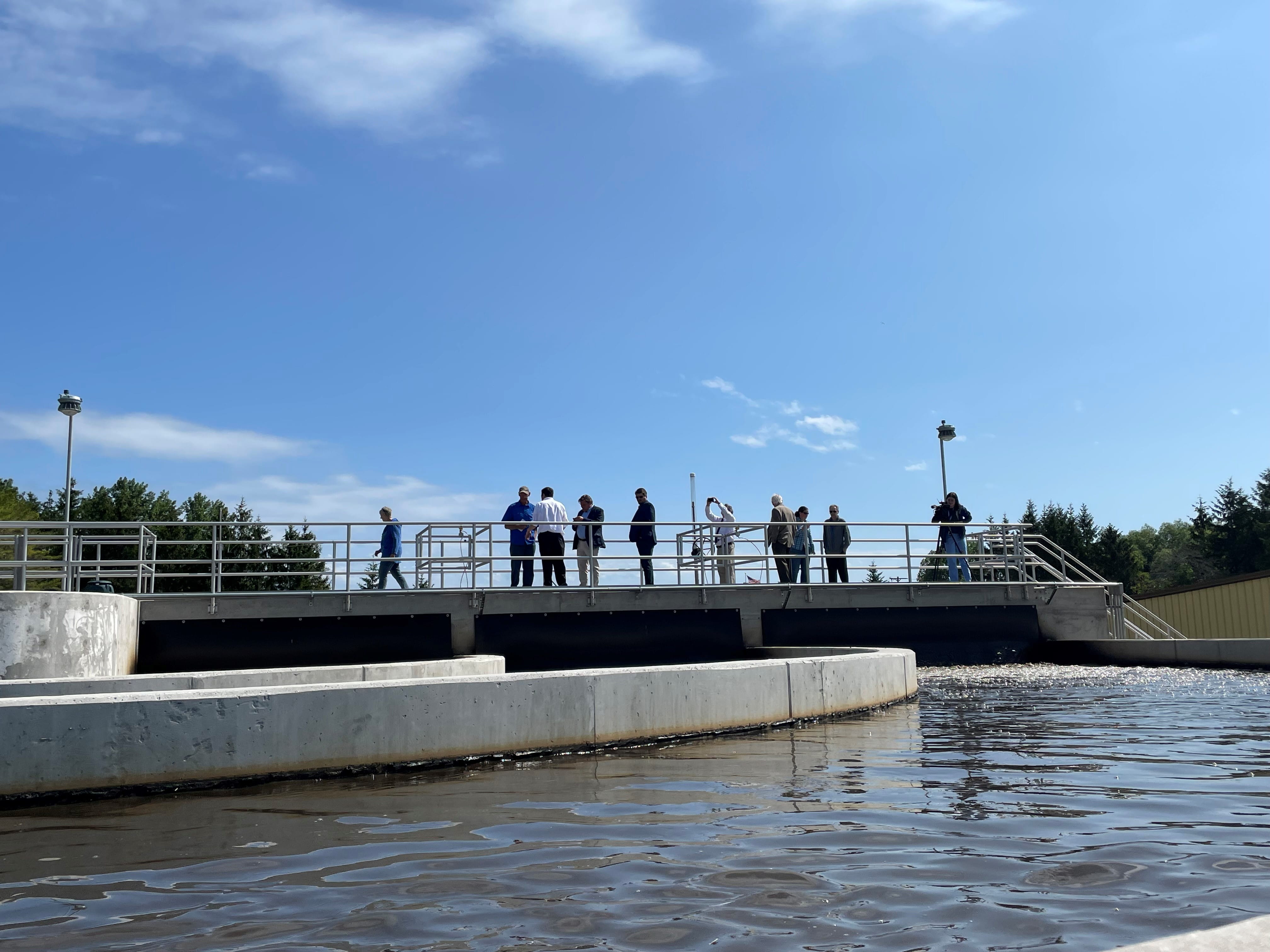 Local and state officials visit upgrades to the Cheboygan wastewater facility, which uses bacteria in place of chemical treatment, in summer 2023.