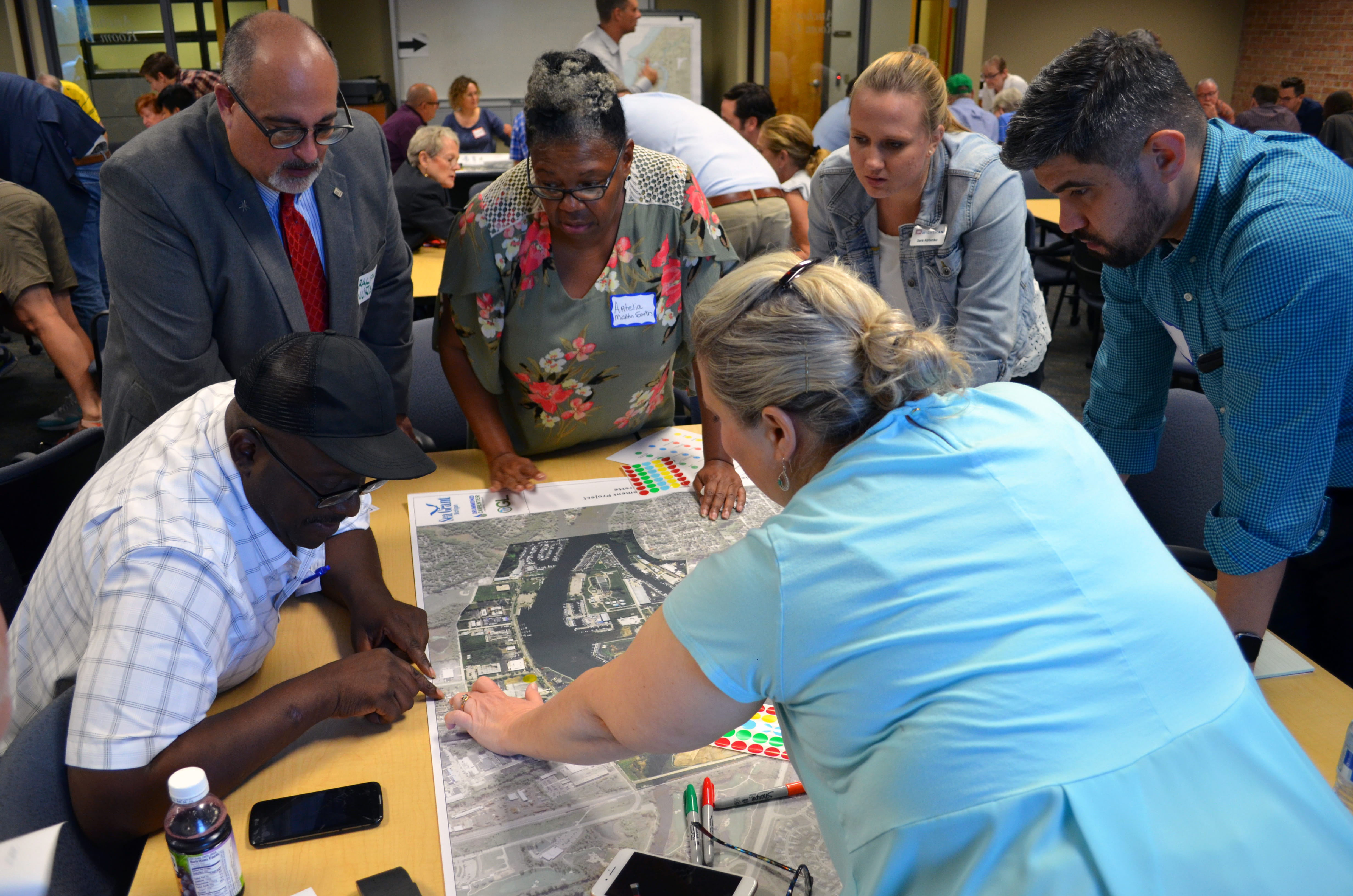 Community members from St. Joseph and Benton Harbor study an area map during an open house to mark assets and areas that need improvements. Photo courtesy of Michigan Sea Grant.