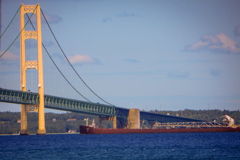 Great Lakes freighter heading west under the Mackinac Bridge