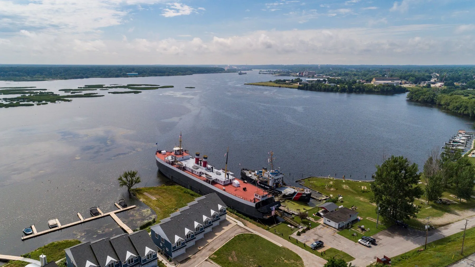 Aerial view of U.S. Coast Guard Station Manistee and the S.S. City of Milwaukee in Manistee Lake 