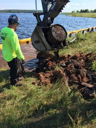 Drums being removed from immediately beneath the Superfund vegetated soil cap in the Hubbell Processing area.