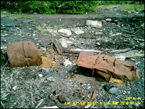 Drums on the ground surface with debris