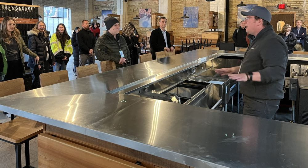 Heath Bobick, EGLE Bay City brownfield coordinator, at the North Peak site, explains the history of brownfield sites in Bay City and their transformation.