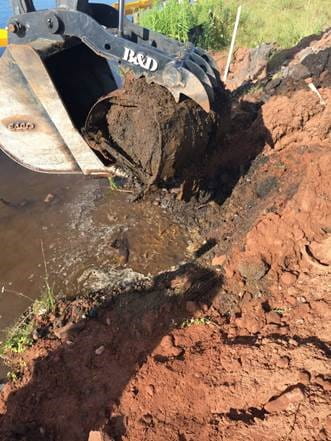 Drums being removed from immediately beneath the Superfund vegetated soil cap in the Hubbell Processing area.