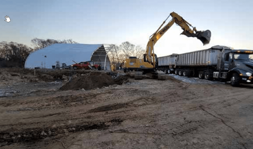 Another view of excavation at Spartan Chemical. Crane is putting contaminated topsoil into trucks for removal.