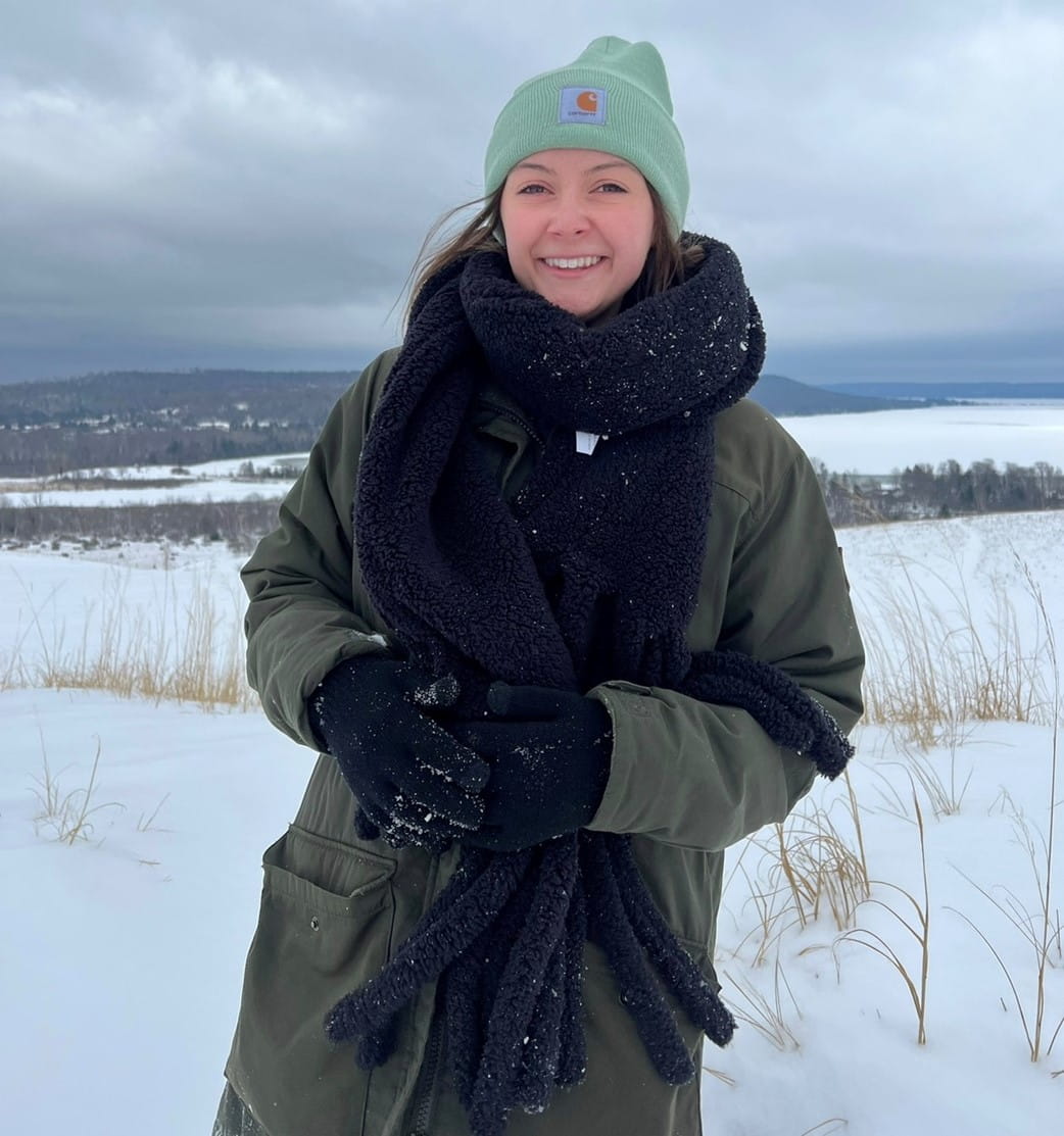 Intern Haley Neuenfeldt climbing the snowy Sleeping Bear Dunes in Glen Arbor.
