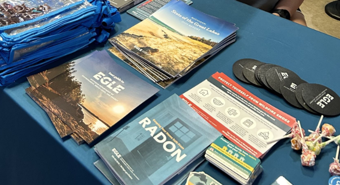 Various EGLE publications and outreach materials on a table
