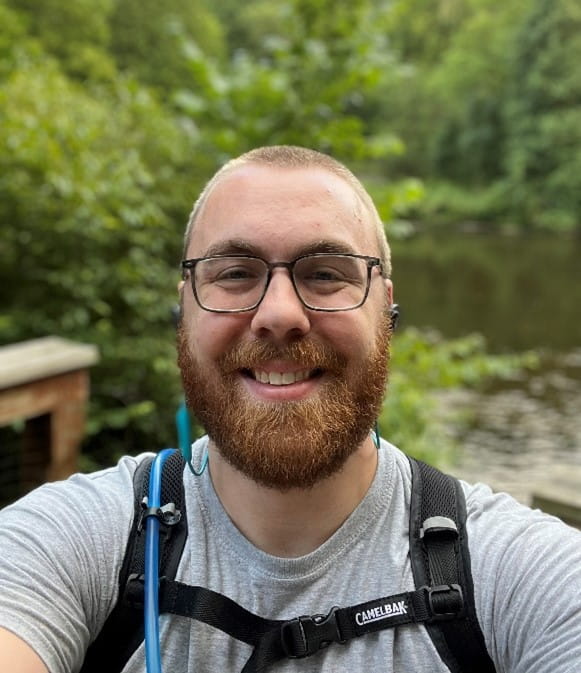 Climate Action Officer Zach Richardson biking the White Pine Trail. 