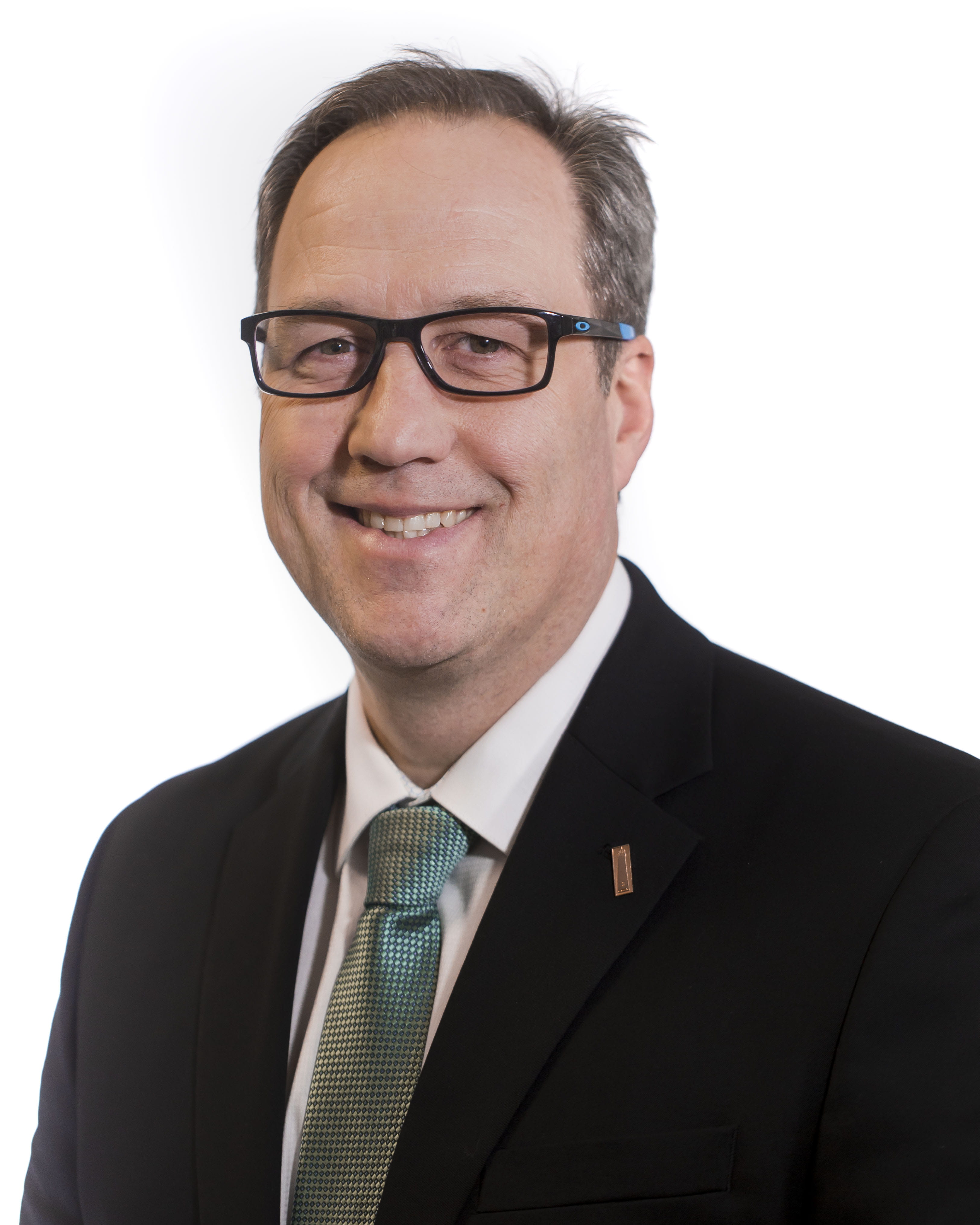 Adam Wygant wearing a suitcoat and smiling