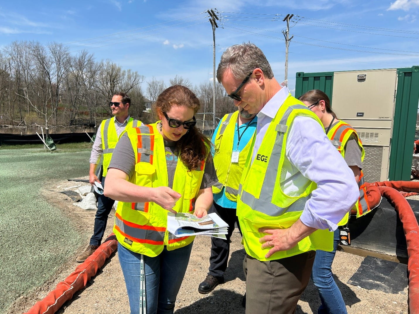 Karen Vorce, EGLE supervisor, and EGLE Director Phil Roos look at documents at a Wolverine Worldwide PFAS site.