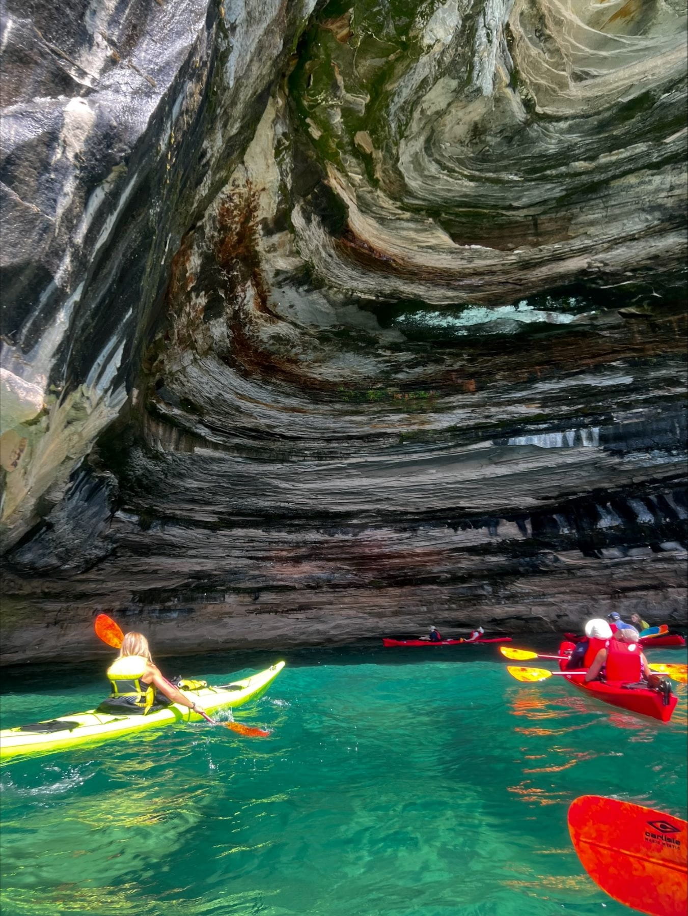 EGLE staffer Sydnie Burch kayaking with others at Pictured Rocks.