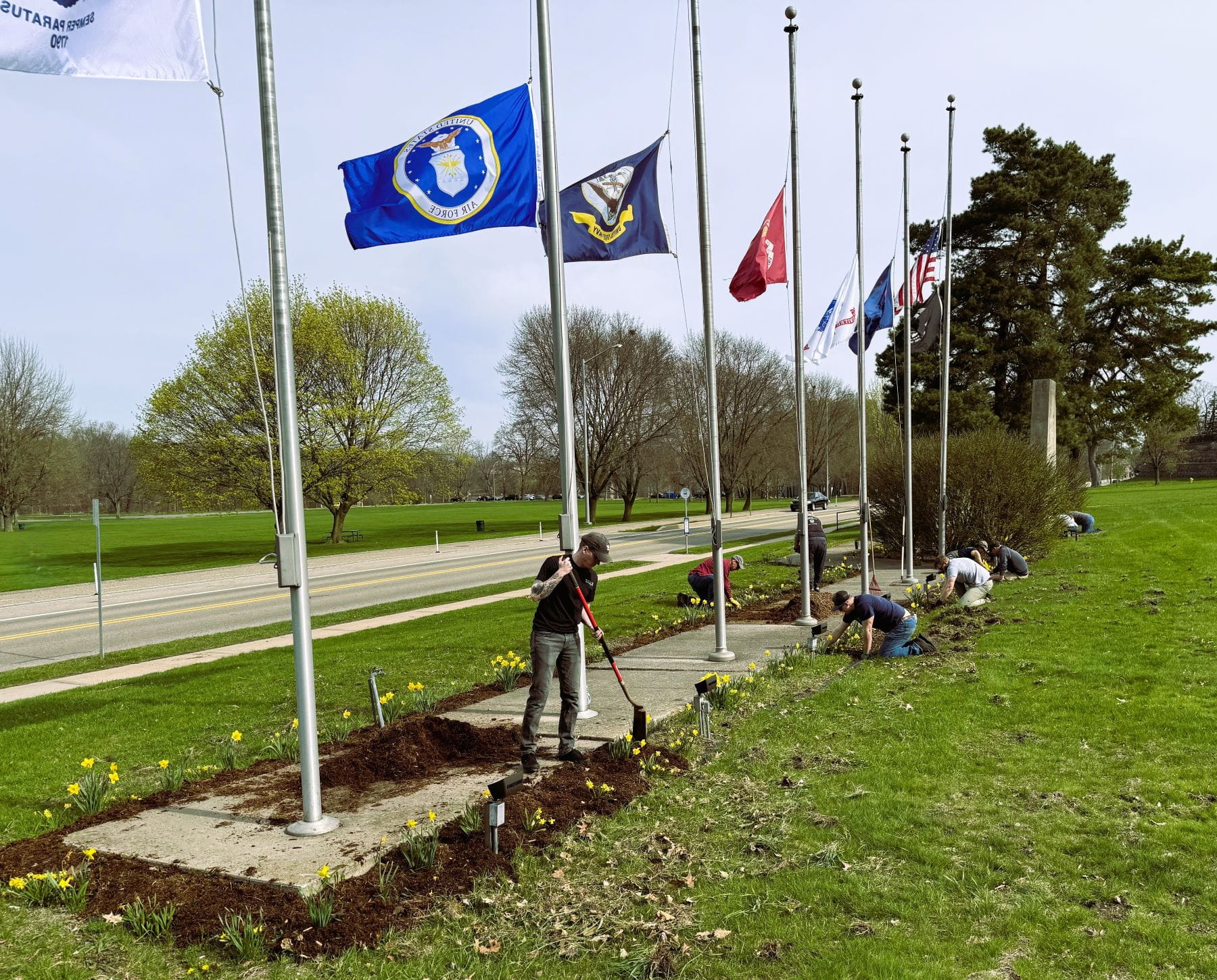 Zach Fleet (EGLE) (foreground) and other volunteers pulling weeds and placing mulch during MVHGR beautification event.