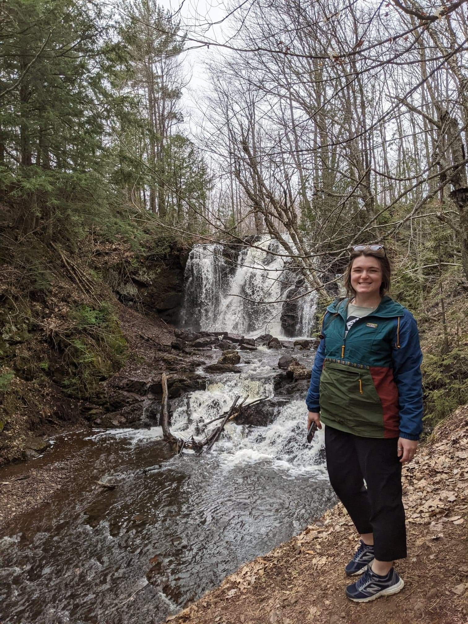 Allyson Hartz, daughter of Andy Hartz, in front of waterfall. She is also an EGLE staffer.