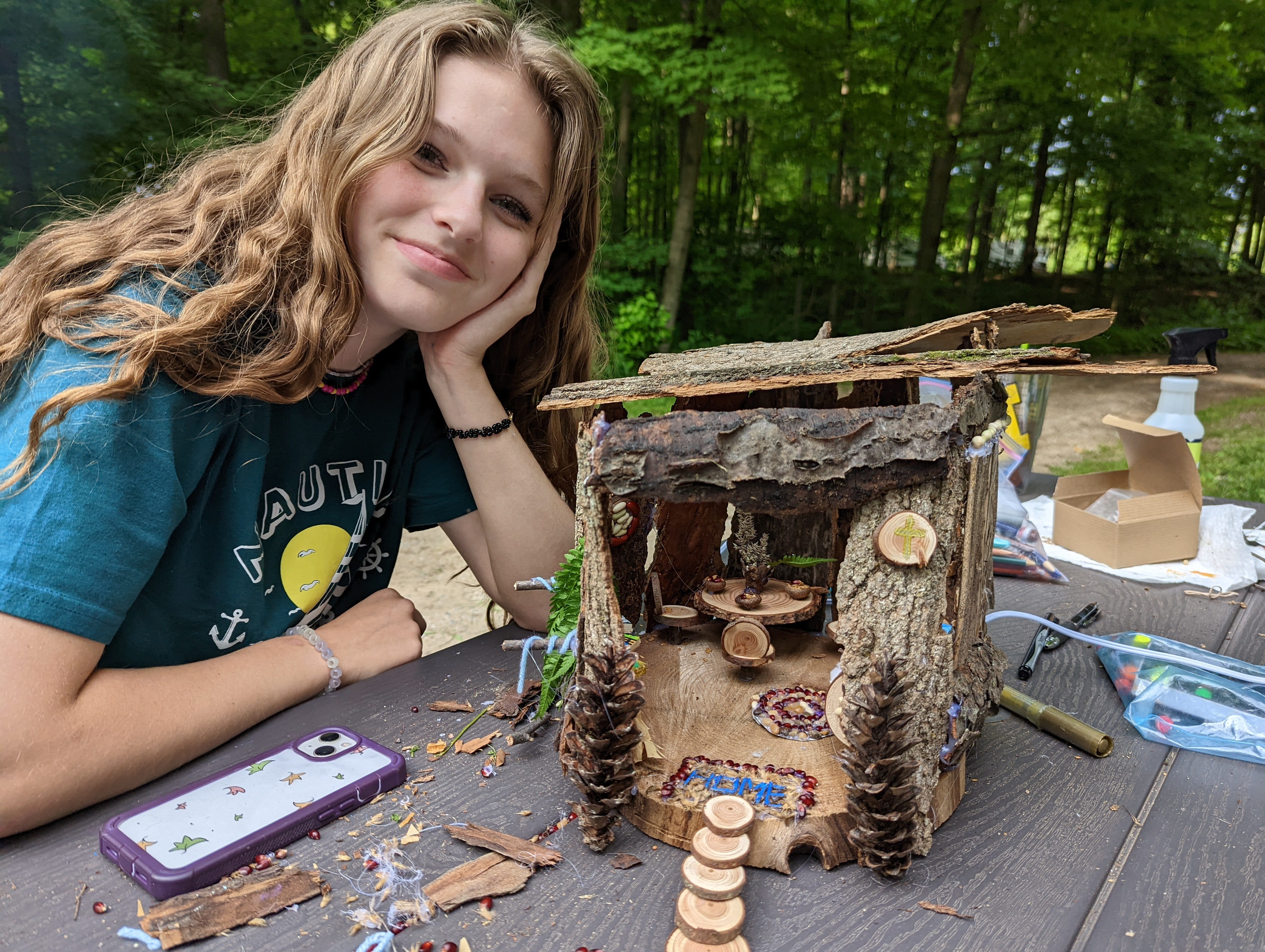 Izzy Cuncannon, daughter of Nancy Cuncannon, next to a fairy house she built.