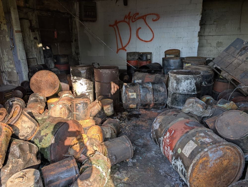 Drums filled with unknown hazardous chemicals and chemical waste in an abandoned warehouse in Detroit.