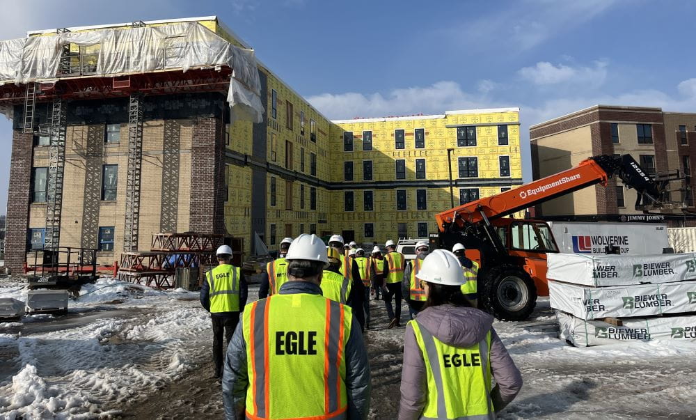 EGLE, MSHDA, MEDC, local officials, developers, and community stakeholders tour the second phase of the Cadillac Lofts brownfield redevelopment. 