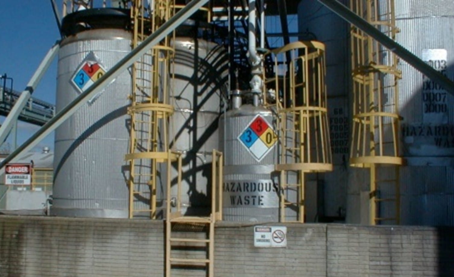 Hazardous waste tanks surrounded by ladders at an hazardous waste facility