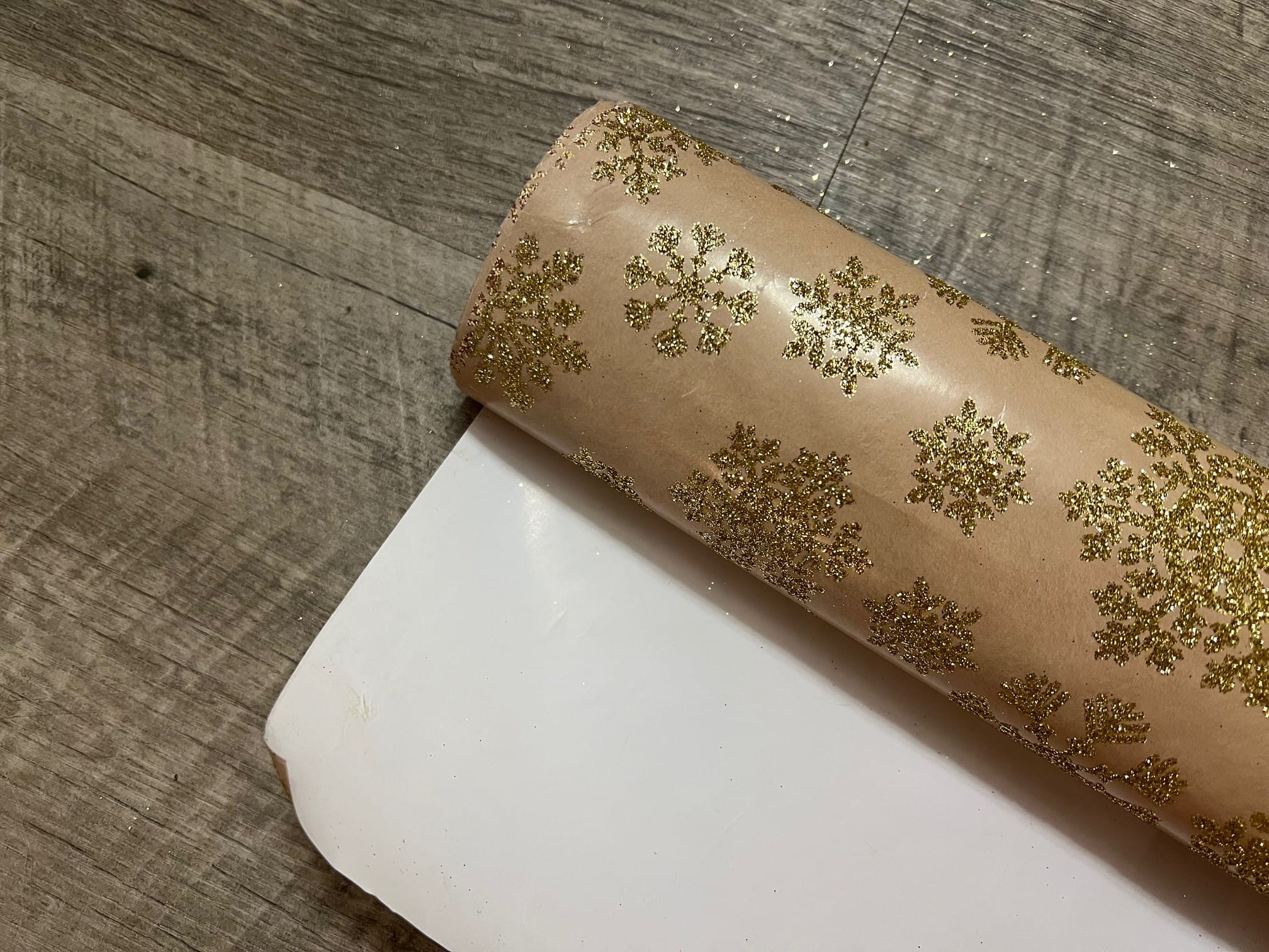 Peach wrapping paper with gold glitter snowflakes
