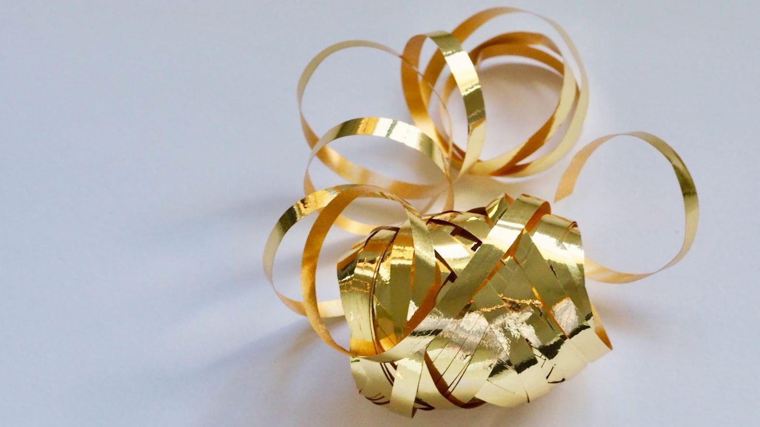 A spool of metallic gold ribbon